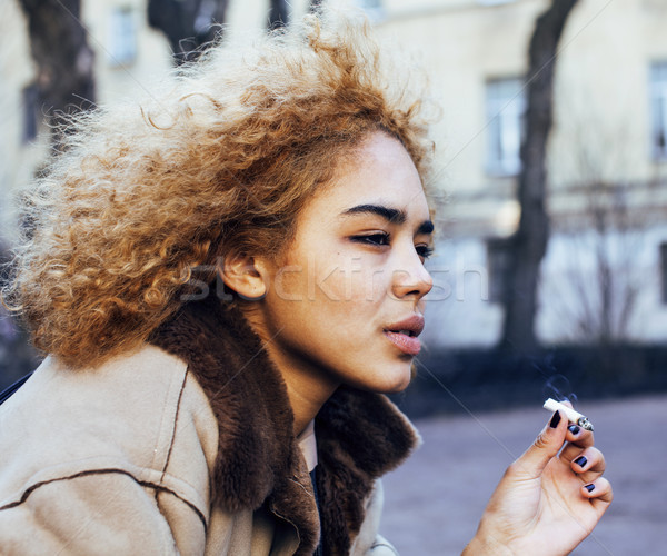 young pretty girl teenage outside smoking cigarette, looking lik Stock photo © iordani