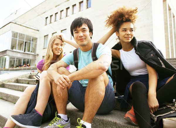 cute group of teenages at the building of university with books  Stock photo © iordani