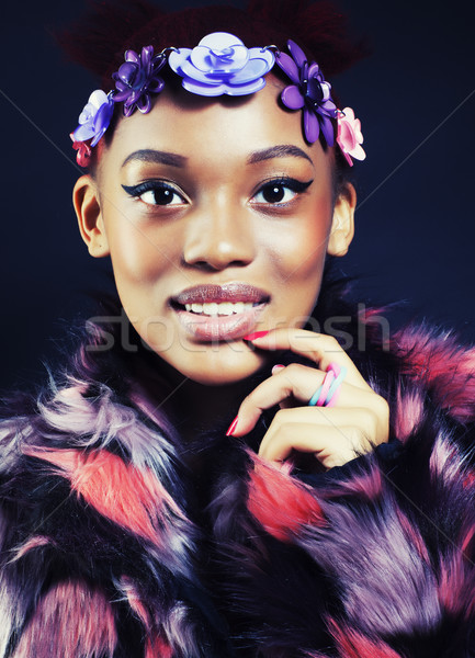 young pretty african american woman in spotted fur coat and flowers jewelry on head smiling sweet et Stock photo © iordani