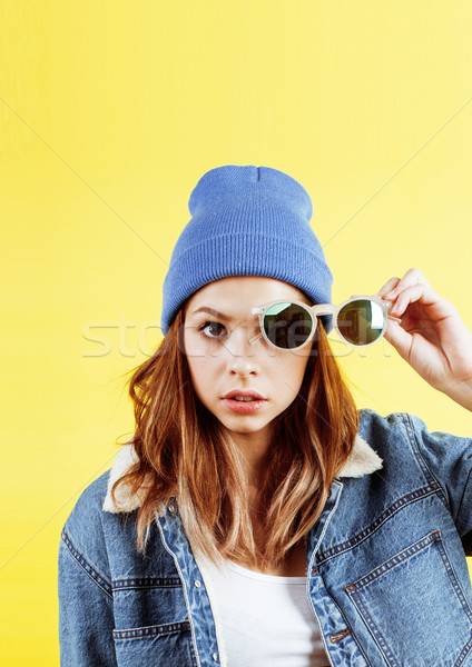 young pretty teenage woman emotional posing on yellow background, fashion lifestyle people concept  Stock photo © iordani