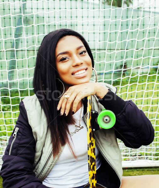 cool pretty smiling afro-american happy young woman with skate b Stock photo © iordani