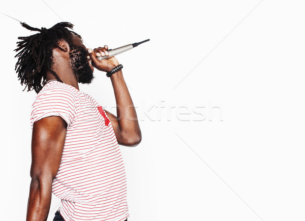 Stock photo: young handsome african american boy singing emotional with microphone isolated on white background, 