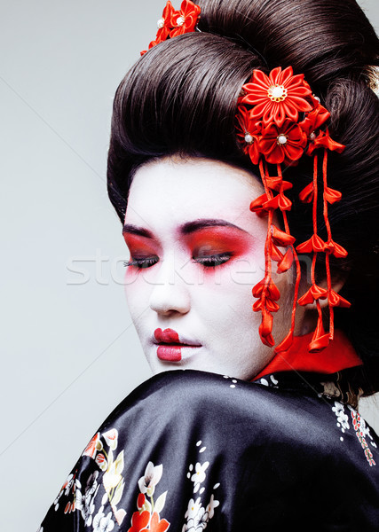 young pretty geisha in black kimono among sakura, asian ethno close up Stock photo © iordani