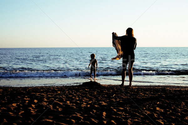 young mother with son resting on sea coast, happy family togethe Stock photo © iordani