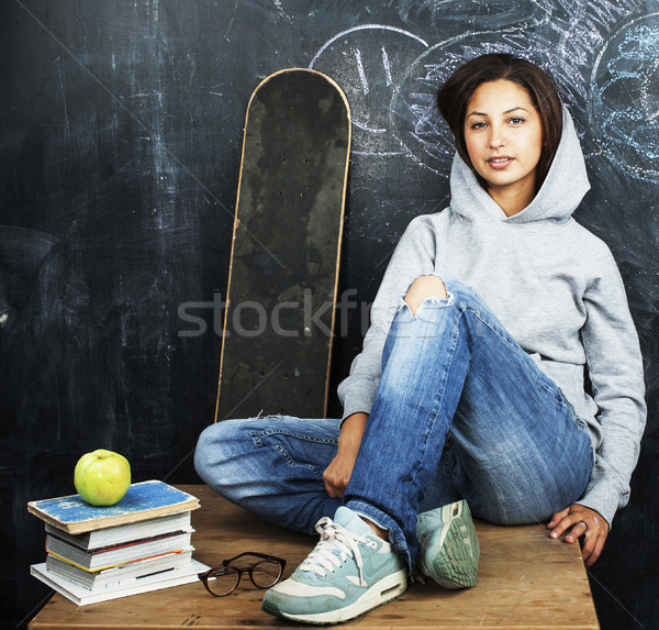 young cute teenage girl in classroom at blackboard seating on ta Stock photo © iordani