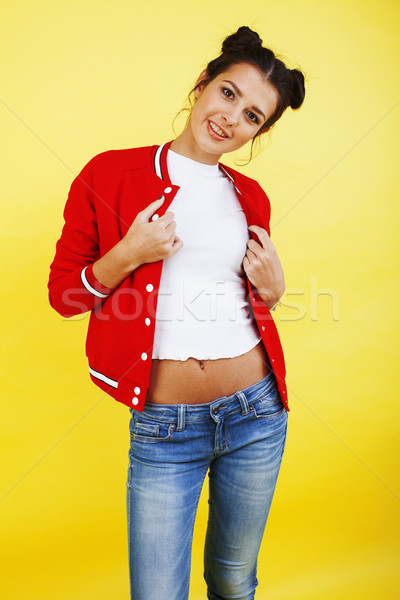 young pretty teenage girl emotional posing on yellow background, fashion lifestyle people concept  Stock photo © iordani
