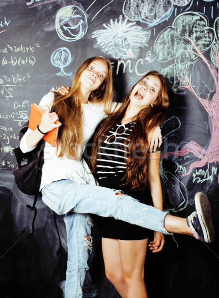 back to school after summer vacations, two teen real girls in classroom with blackboard painted toge Stock photo © iordani