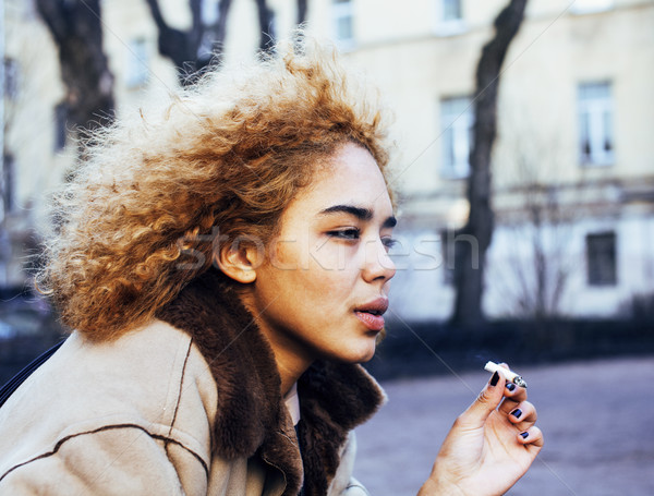 young pretty girl teenage outside smoking cigarette close up, looking like real junky, social issues Stock photo © iordani