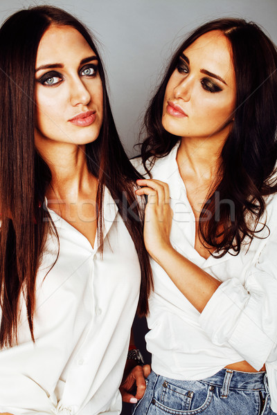 two sisters twins posing, making photo selfie, dressed same whit Stock photo © iordani