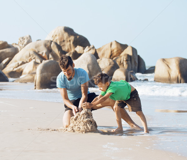 happy family on beach playing, father with son walking sea coast Stock photo © iordani