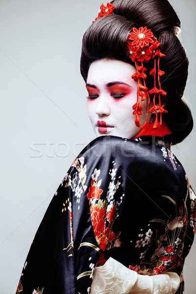 young pretty geisha in black kimono among sakura, asian ethno Stock photo © iordani