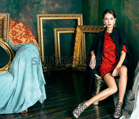 beauty rich brunette woman in luxury interior near empty frames, wearing fashion clothes, lifestyle  Stock photo © iordani