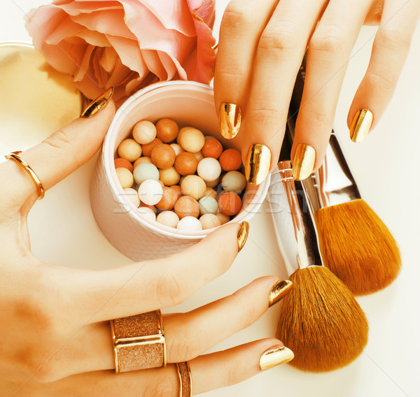 woman hands with golden manicure and many rings holding brushes, Stock photo © iordani