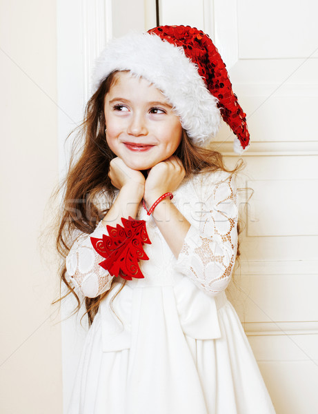 little cute girl in santas red hat waiting for Christmas gifts.  Stock photo © iordani
