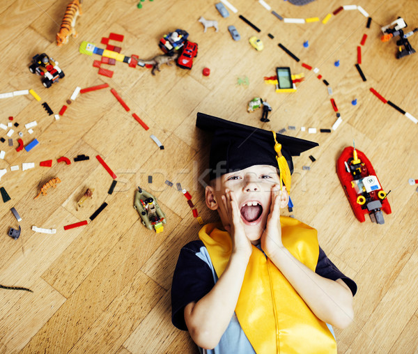 Stock photo: little cute preschooler boy among toys lego at home in graduate 