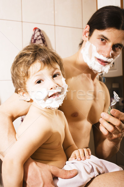 Portrait of son and father enjoying while shaving together Stock photo © iordani