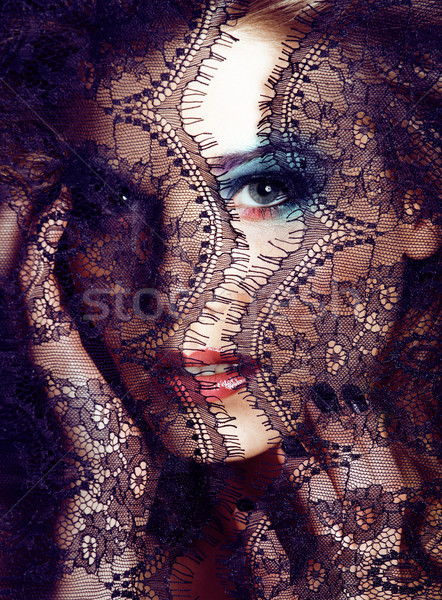 portrait of beauty young woman through lace close up mistery makeup sexy, fashion people concept Stock photo © iordani