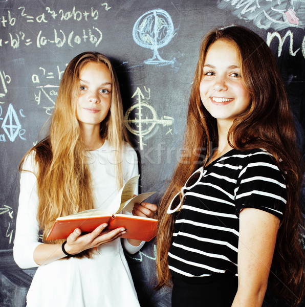 back to school after summer vacations, two teen real girls in classroom with blackboard painted toge Stock photo © iordani