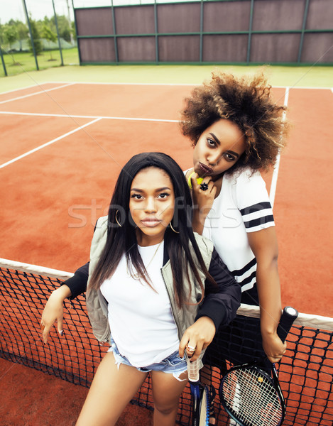 young pretty girlfriends hanging on tennis court, fashion stylis Stock photo © iordani