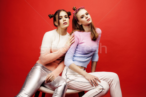 two best friends teenage girls together having fun, posing emotional on red background, besties happ Stock photo © iordani
