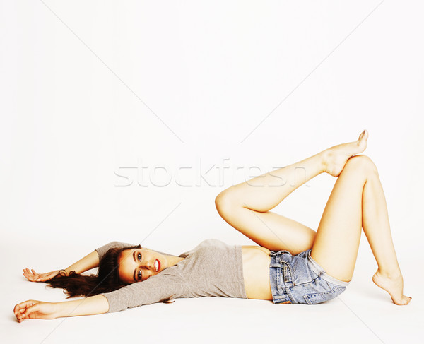 young pretty brunette woman head over heels on white isolated Stock photo © iordani