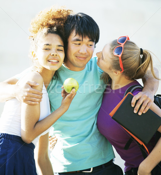 cute group of teenages at the building of university with books huggings Stock photo © iordani