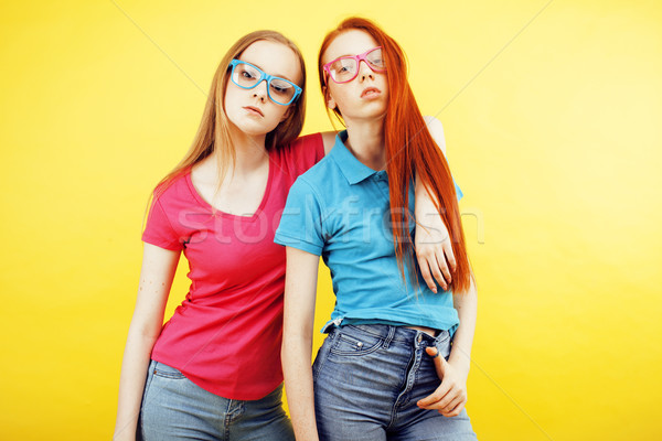 lifestyle people concept: two pretty school girl having fun on yellow background, happy smiling stud Stock photo © iordani