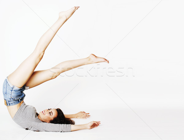 young pretty brunette woman head over heels on white isolated Stock photo © iordani
