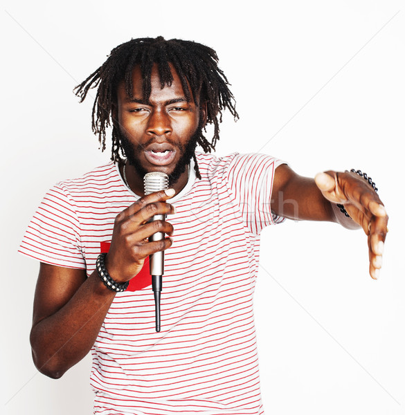 young handsome african american boy singing emotional with microphone isolated on white background,  Stock photo © iordani