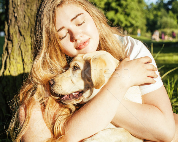 young attractive blond woman playing with her dog in green park at summer, lifestyle people concept Stock photo © iordani