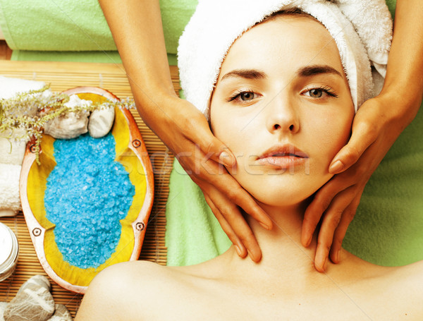 stock photo attractive lady getting spa treatment in salon, close up asian tan hands on face Stock photo © iordani