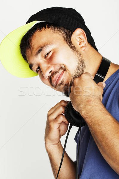 Stock photo: young asian man in hat and headphones listening music on white b