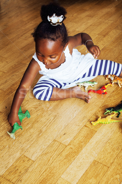 little cute african american girl playing with animal toys at ho Stock photo © iordani