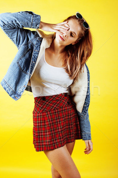 lifestyle people concept: pretty young school teenage girl having fun happy smiling on yellow backgr Stock photo © iordani