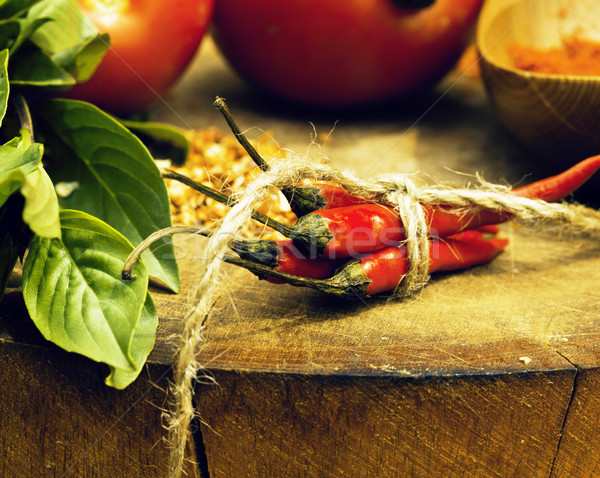 vegetables on wooden kitchen with spicies, tomato, chilli, green Stock photo © iordani