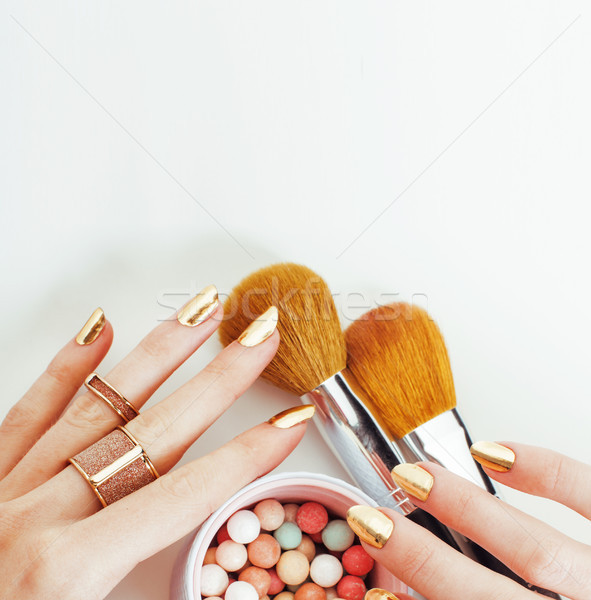 Stock photo: woman hands with golden manicure  many rings holding brushes, make up artist stuff stylish and pure