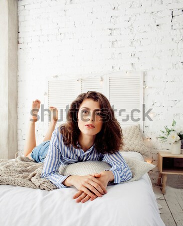 young pretty brunette woman in her bedroom sitting at window, happy smiling lifestyle people concept Stock photo © iordani