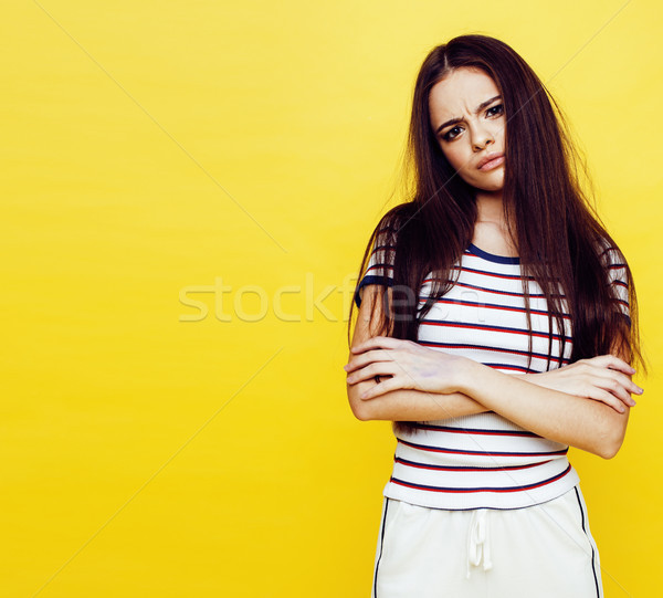 young pretty teenage woman angry posing on yellow background, fashion lifestyle people concept  Stock photo © iordani