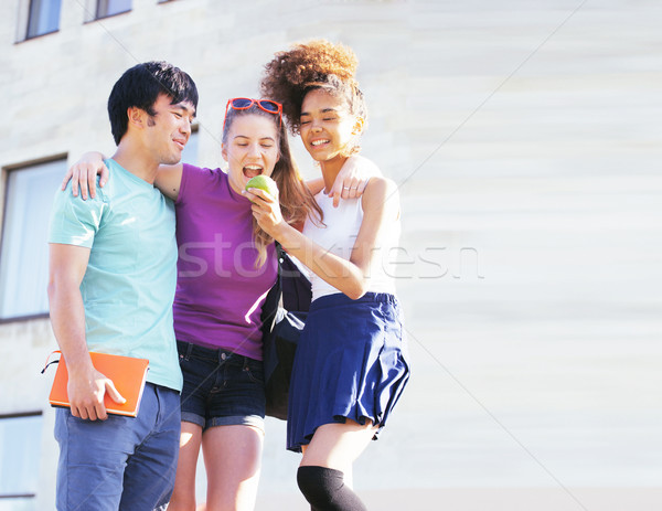 cute group of teenages at the building of university with books huggings, back to school Stock photo © iordani