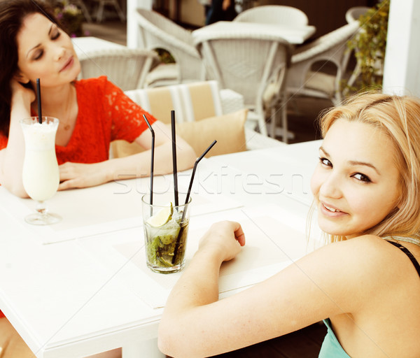 portrait of two pretty friends in cafe drinking and talking Stock photo © iordani
