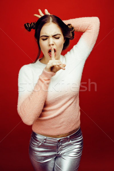 young pretty emitonal posing teenage girl on bright red background, happy smiling lifestyle people c Stock photo © iordani