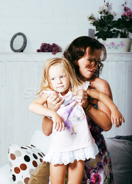 happy smiling mother with little cute daughter at home interior, casual look modern real family, lif Stock photo © iordani