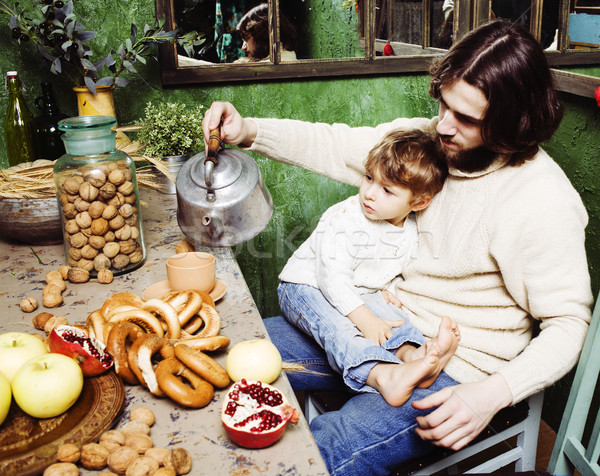 father with beard holding son at countryside vintage kitchen close up Stock photo © iordani