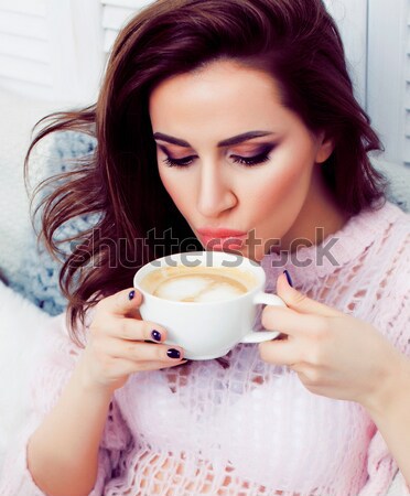 young pretty brunette girl laying in cozy bed with coffee wearing wool winter sweater happy smiling, Stock photo © iordani