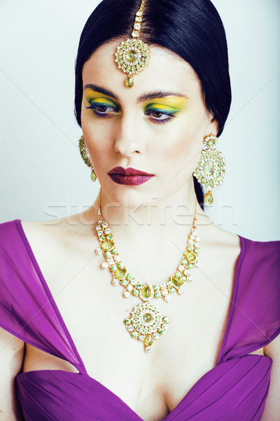 young pretty caucasian woman like indian in ethnic jewelry close up on white, bridal makeup Stock photo © iordani