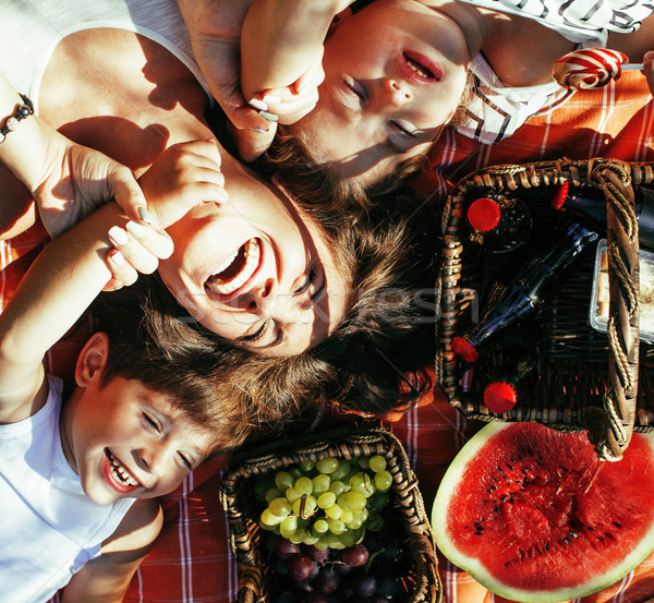 cute happy family on picnic laying on green grass mother and kids, warm summer vacations Stock photo © iordani