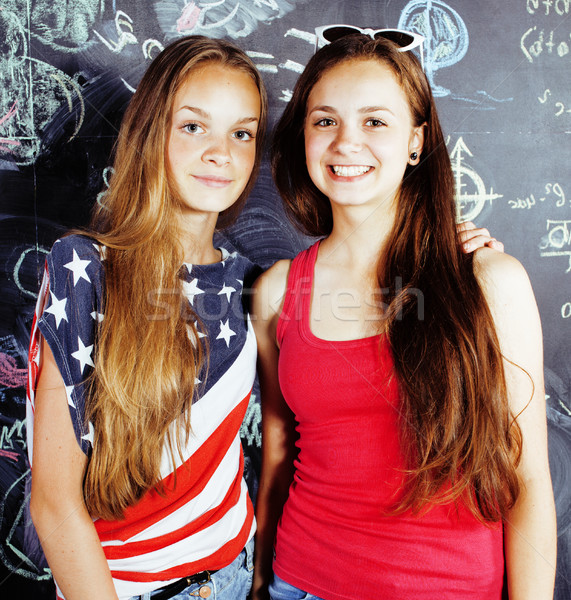 back to school after summer vacations, two teen real girls in classroom with blackboard painted toge Stock photo © iordani