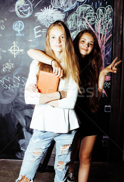back to school after summer vacations, two teen real girls in classroom with blackboard painted toge Stock photo © iordani