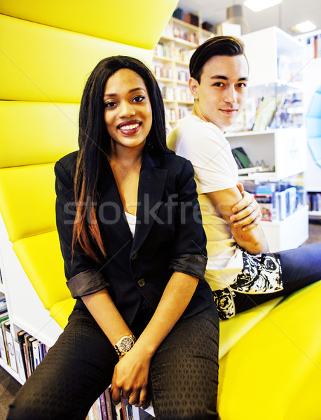 couple students in univercity library, looking book, preparing t Stock photo © iordani