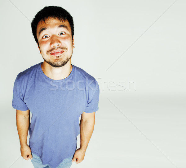 young cute asian man on white background gesturing emotional, po Stock photo © iordani